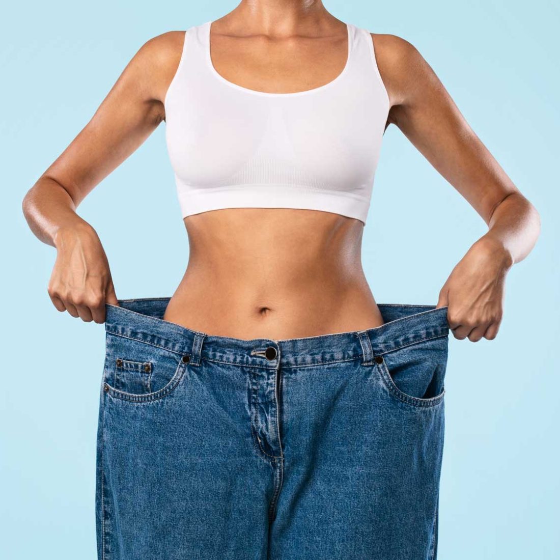 woman-holding-oversized-jeans-after-weight-loss-2026-03-24-02-19-43-utc